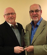 Dr. Tunnicliffe (left) presents the award to Graham Power