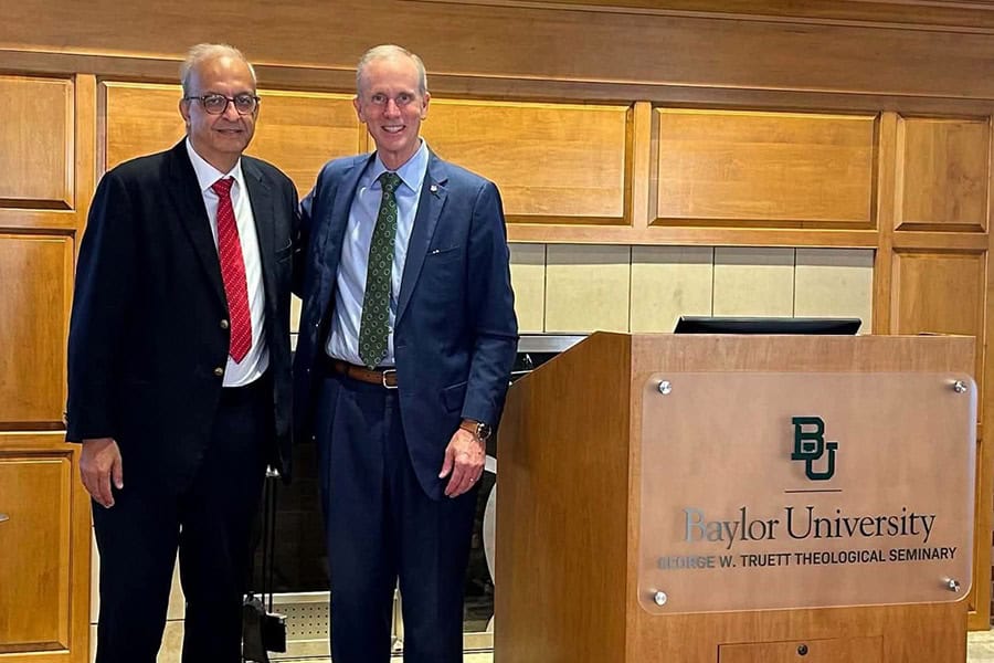 Rev. Botrus Mansour and Dr. Todd Still standing beside a Baylor University lectern.