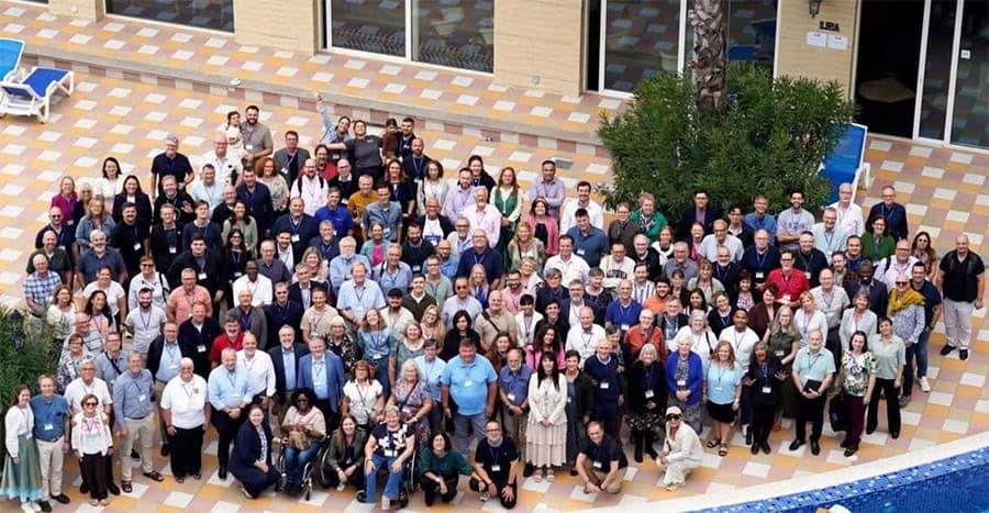 Large group photo of conference attendees outdoors