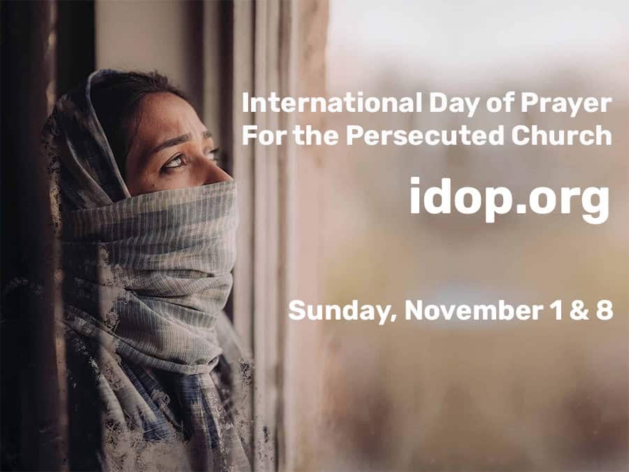 Woman with head covering gazing out window for IDOP